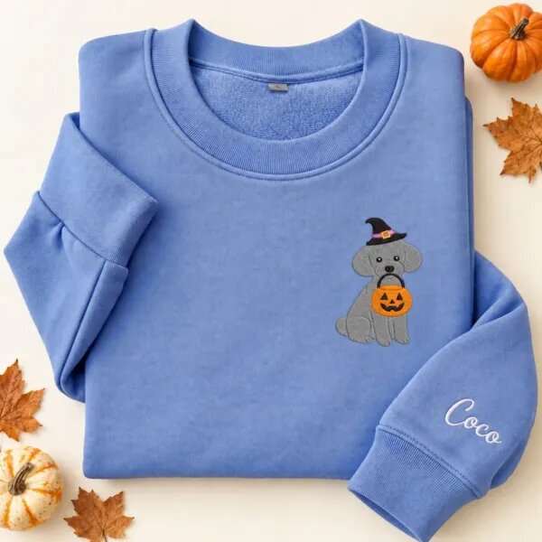 Embroidered Toy Poodle Halloween sweatshirt in Heather Deep Royal with a witch-hat Toy Poodle holding a pumpkin bucket on the left chest