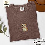Espresso Comfort Colors T-shirt embroidered with a fawn and cream English bulldog puppy in a red collar chewing a string of Christmas lights