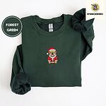 Forest Green crewneck sweatshirt folded on a white background, embroidered with a fawn English bulldog in a red Santa suit, black belt and Santa hat