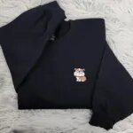 Black English bulldog crewneck folded with the mini bulldog pocket logo embroidery on the chest