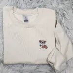 English bulldog crewneck in Sand with the embroidered brown and white bulldog on the left chest