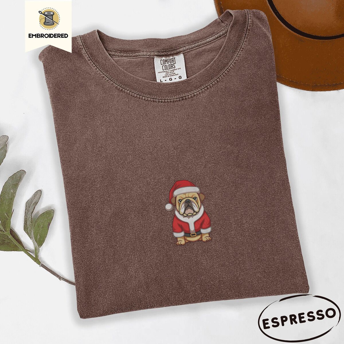 English Bulldog Santa Shirt – Espresso Espresso Comfort Colors T-shirt embroidered with a fawn English bulldog in a red Santa suit, black belt and Santa hat