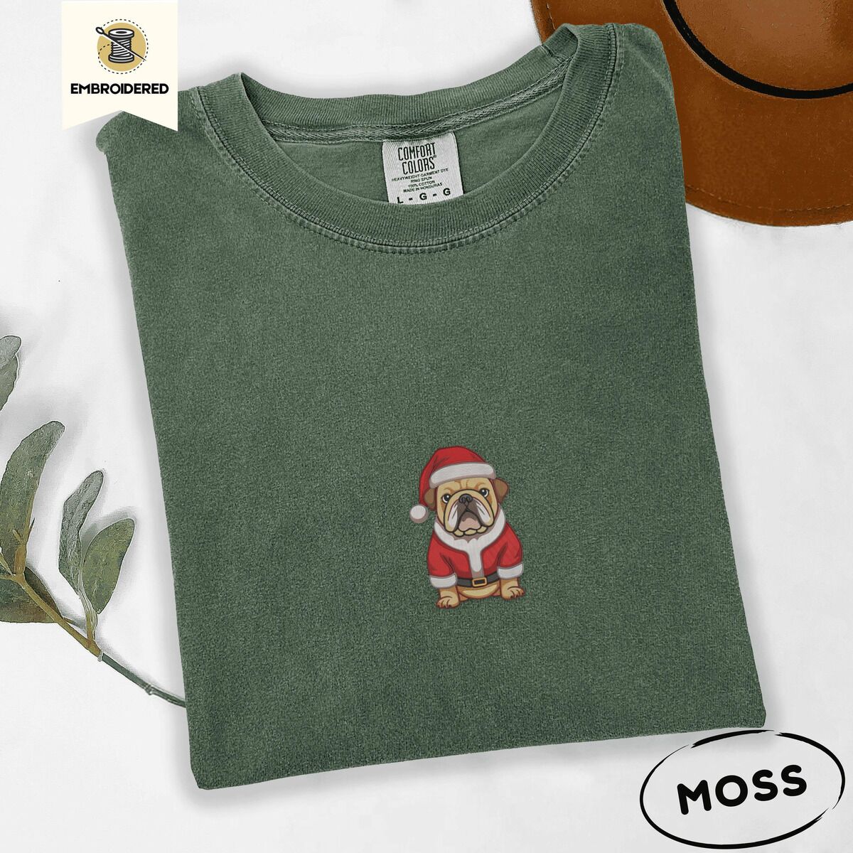 English Bulldog Santa Shirt – Moss Moss Comfort Colors T-shirt embroidered with a fawn English bulldog in a red Santa suit, black belt and Santa hat