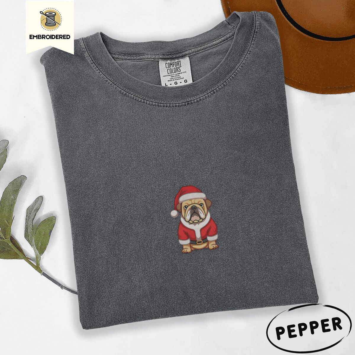 English Bulldog Santa Shirt – Pepper Pepper Comfort Colors T-shirt embroidered with a fawn English bulldog in a red Santa suit, black belt and Santa hat