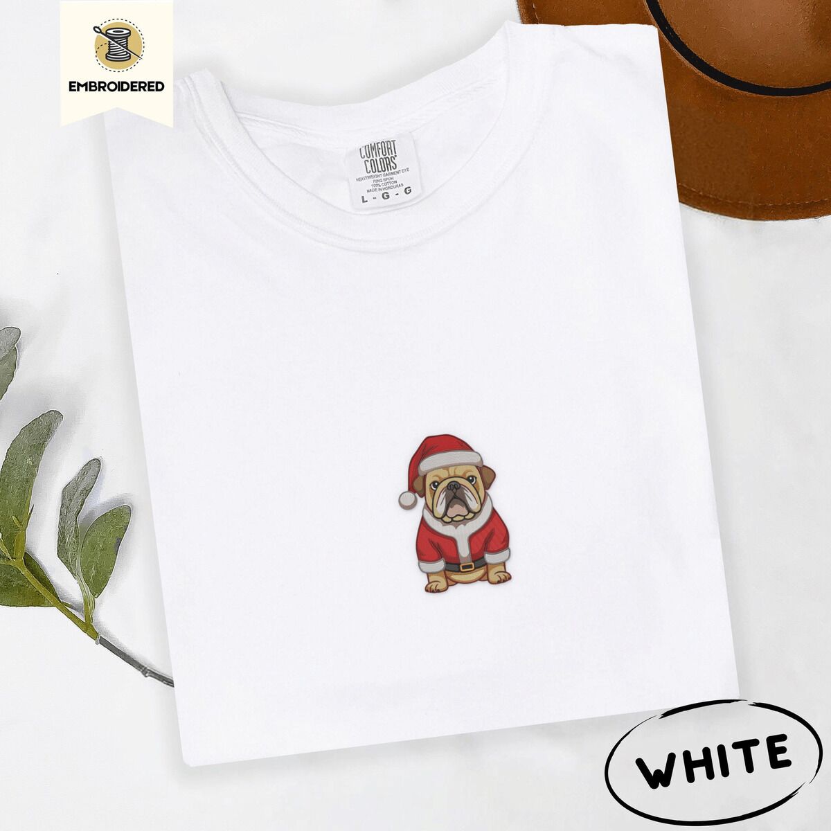 English Bulldog Santa Shirt – White White Comfort Colors T-shirt embroidered with a fawn English bulldog in a red Santa suit, black belt and Santa hat