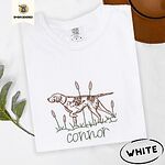 White Comfort Colors T-shirt embroidered with a liver and white English pointer on point among cattails and grass, with an optional name stitched below