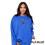 Woman in an oversized Flo Blue crewneck sweatshirt embroidered with a golden retriever in a Santa hat and Christmas lights