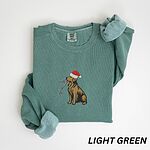 Festive golden retriever sweatshirt in Light Green laid flat with rolled cuffs, embroidered with a golden in a Santa hat holding Christmas lights