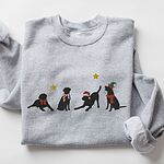 Sport Grey crewneck sweatshirt laid flat with folded sleeves, embroidered with four black Labrador silhouettes in a bow, a candy-cane scarf, a Santa hat and an elf hat under gold stars