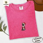Crunchberry Comfort Colors T-shirt embroidered with a black French bulldog with a cream chest in a Santa hat and a red scarf with white zigzag stripes