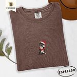 Espresso Comfort Colors T-shirt embroidered with a black French bulldog with a cream chest in a Santa hat and a red scarf with white zigzag stripes