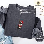Dark Heather crewneck sweatshirt folded with ripped jeans and a silver chain necklace, embroidered with a black French bulldog with a cream chest in a Santa hat and a red scarf with white zigzag stripes