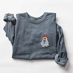 Dark Heather crewneck sweatshirt laid flat with rolled sleeves, embroidered with a little ghost in a rust knit beanie hugging a grey French bulldog on the left chest
