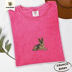 Crunchberry Comfort Colors T-shirt embroidered with a black and tan German shepherd lying down with its ears up and its paws forward