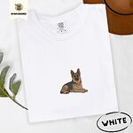 White Comfort Colors T-shirt embroidered with a black and tan German shepherd lying down with its ears up and its paws forward