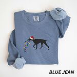 Blue Jean crewneck sweatshirt laid flat, embroidered with a black German shorthaired pointer in a Santa hat carrying Christmas lights