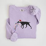 Orchid crewneck sweatshirt laid flat, embroidered with a black German shorthaired pointer in a Santa hat carrying Christmas lights
