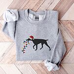 Sport Grey crewneck sweatshirt laid flat on wood, embroidered with a black German shorthaired pointer in a Santa hat carrying a string of Christmas lights