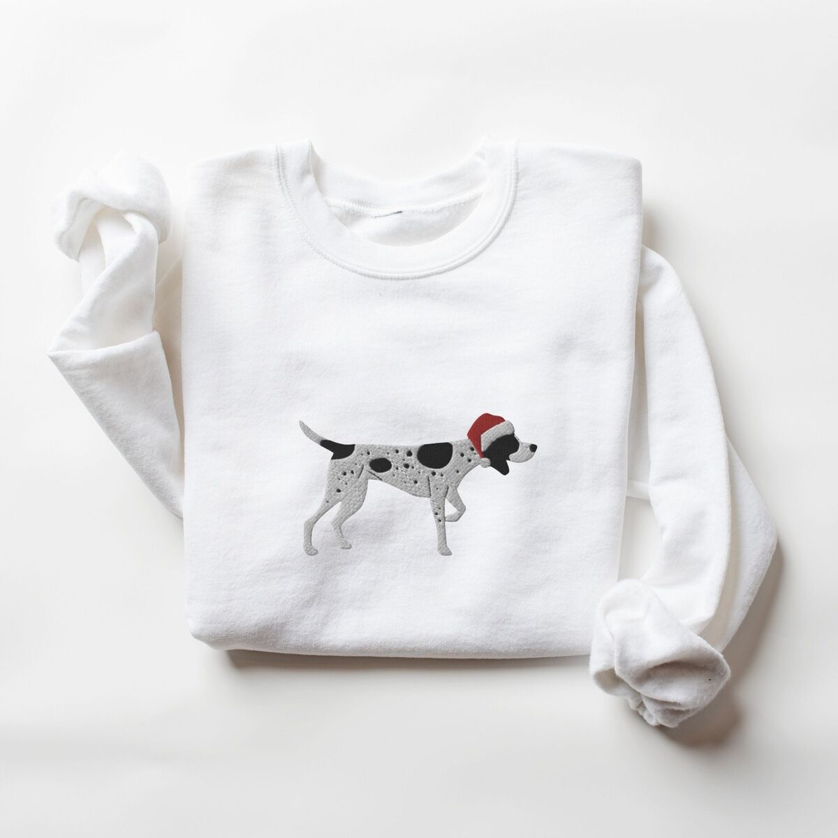 German Shorthaired Pointer Christmas Sweatshirt - White White crewneck sweatshirt laid flat on a white background, embroidered with a black and white ticked German shorthaired pointer in a red Santa hat