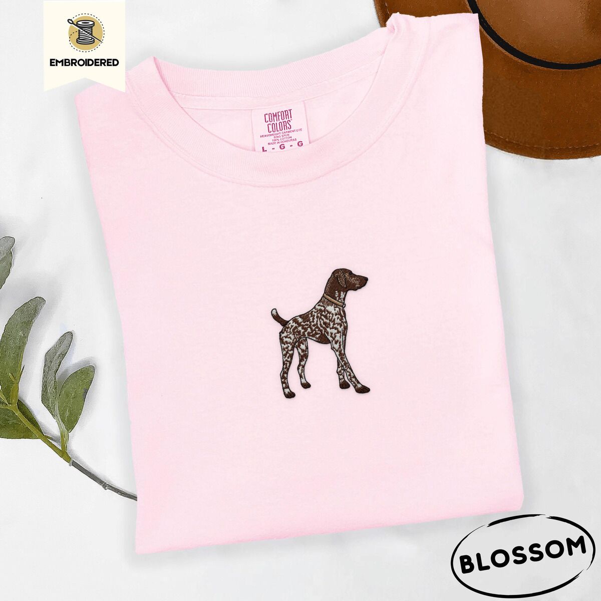 German Shorthaired Pointer Shirt – Blossom Blossom Comfort Colors T-shirt embroidered with a standing liver and white German shorthaired pointer in a tan collar