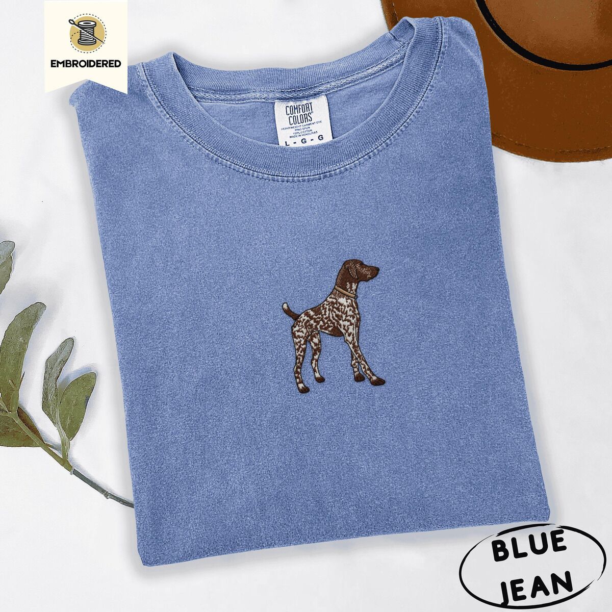 German Shorthaired Pointer Shirt – Blue Jean Blue Jean Comfort Colors T-shirt embroidered with a standing liver and white German shorthaired pointer in a tan collar