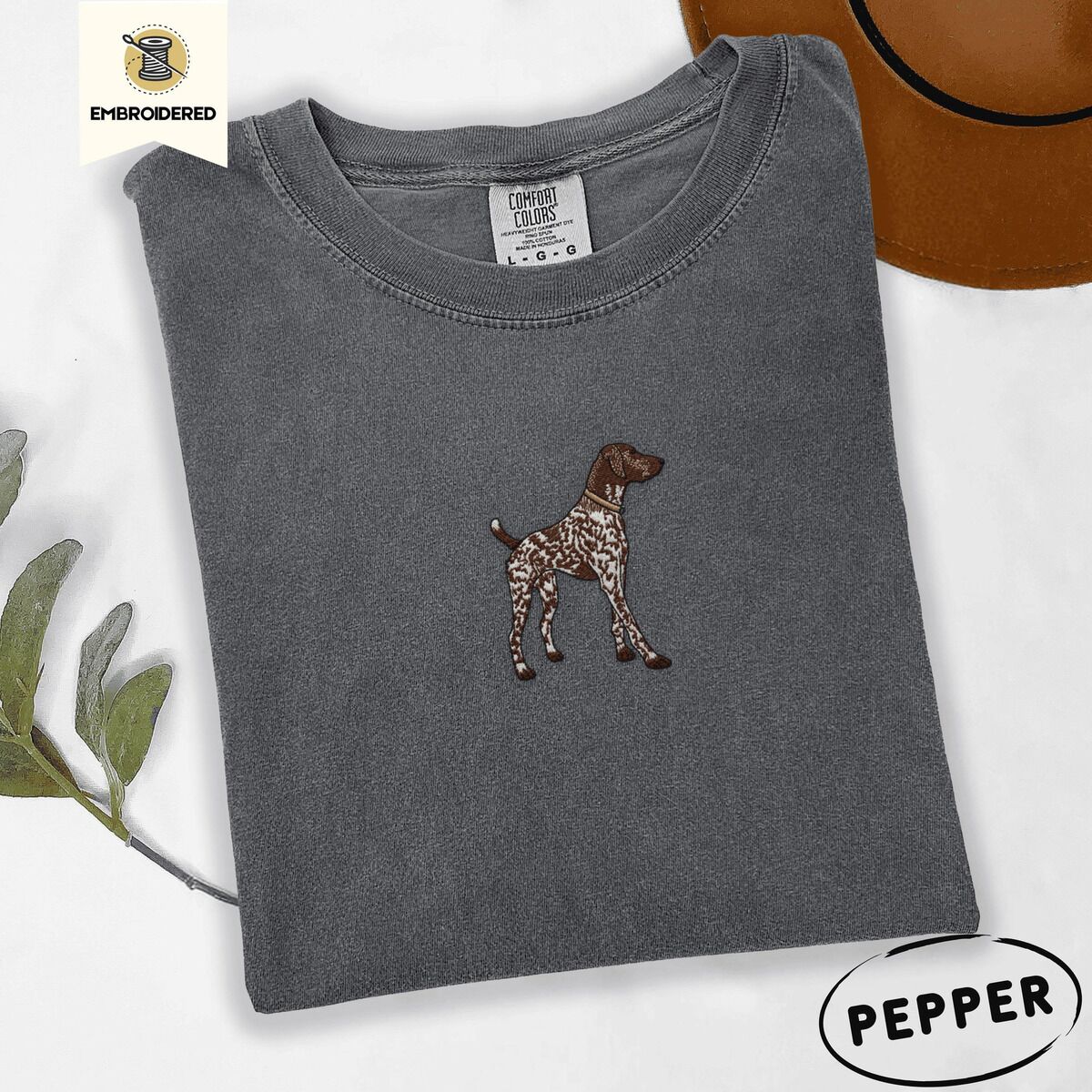 German Shorthaired Pointer Shirt – Pepper Pepper Comfort Colors T-shirt embroidered with a standing liver and white German shorthaired pointer in a tan collar