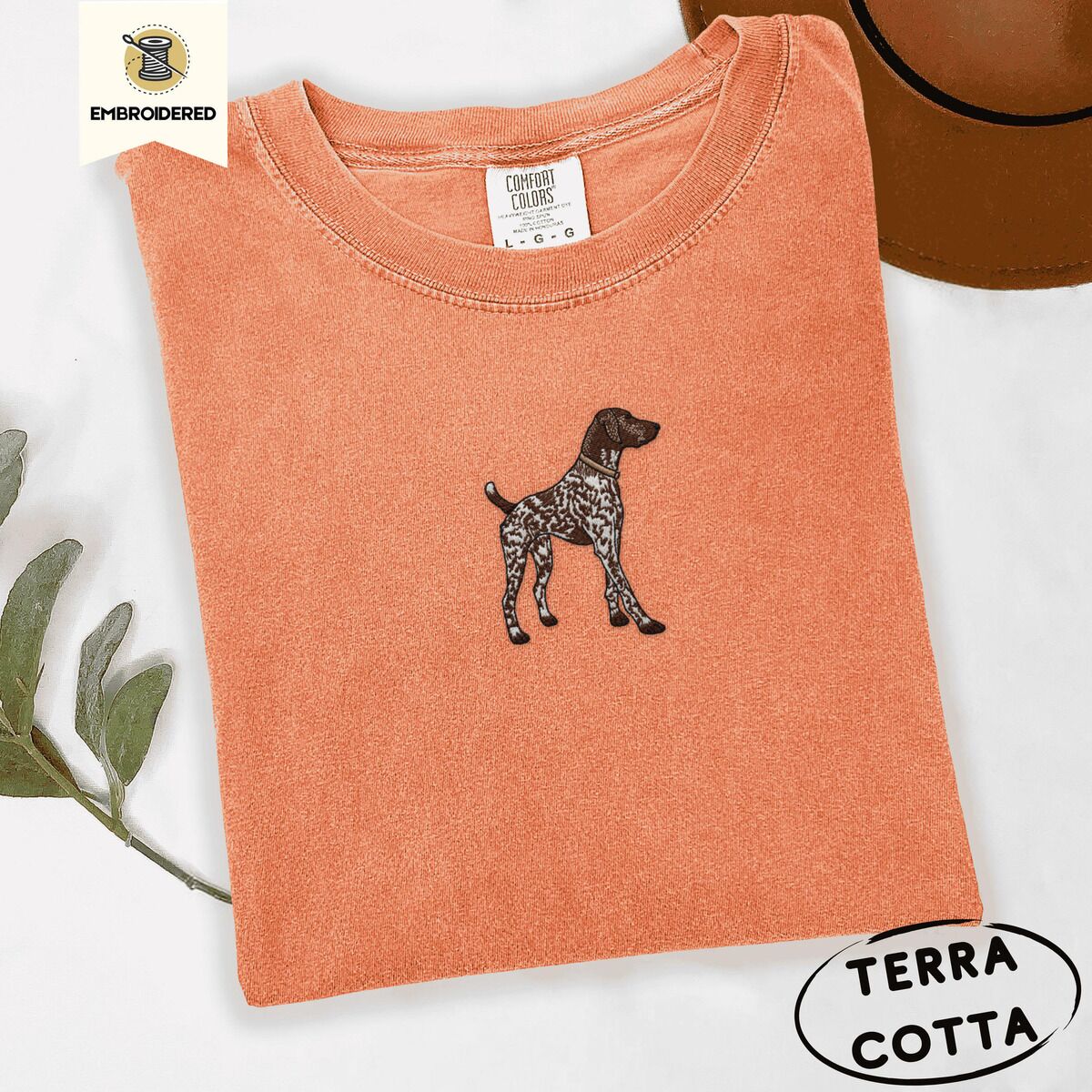 German Shorthaired Pointer Shirt – Terracotta Terracotta Comfort Colors T-shirt embroidered with a standing liver and white German shorthaired pointer in a tan collar