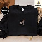 Black crewneck sweatshirt with a brown felt hat and dried bunny tail grass, embroidered with a standing liver and white German shorthaired pointer in a tan collar