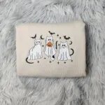 Ghost cat sweatshirt in Sand with three embroidered cats in white ghost sheets, black bats, crescent moons and stars