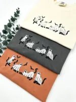 Ghost cats Halloween shirts stacked in Ivory, Pepper and Yam