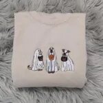 Ghost dog sweatshirt in Sand with three embroidered dogs in white ghost sheets carrying jack-o'-lantern buckets