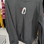 Customer photo: dark gray ghost drinking coffee sweatshirt on a hanger, with the embroidered ghost and black cat on the chest and bats near the cuff