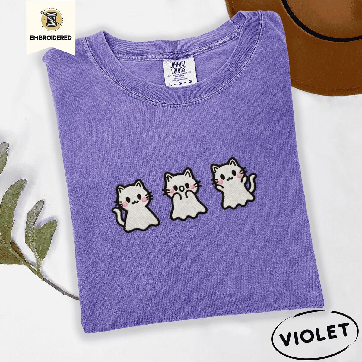 Ghost Kitten Shirt – Violet Violet Comfort Colors T-shirt embroidered with three white ghost kittens with pink cheeks and black outlines