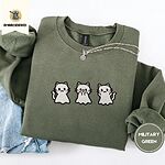 Military Green crewneck sweatshirt folded with light jeans and a silver chain necklace, embroidered with three white ghost kittens with pink cheeks and black outlines