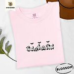 Blossom Comfort Colors T-shirt embroidered with four puppies in white ghost sheets with black floppy ears and tails under three flying black bats