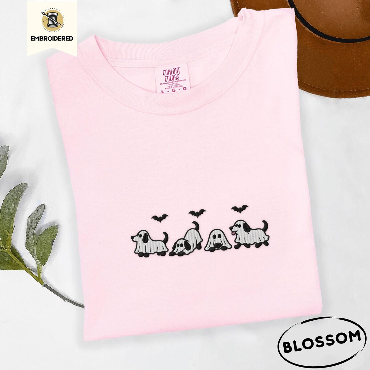Ghost Puppy Shirt – Blossom Blossom Comfort Colors T-shirt embroidered with four puppies in white ghost sheets with black floppy ears and tails under three flying black bats