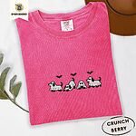 Crunchberry Comfort Colors T-shirt embroidered with four puppies in white ghost sheets with black floppy ears and tails under three flying black bats