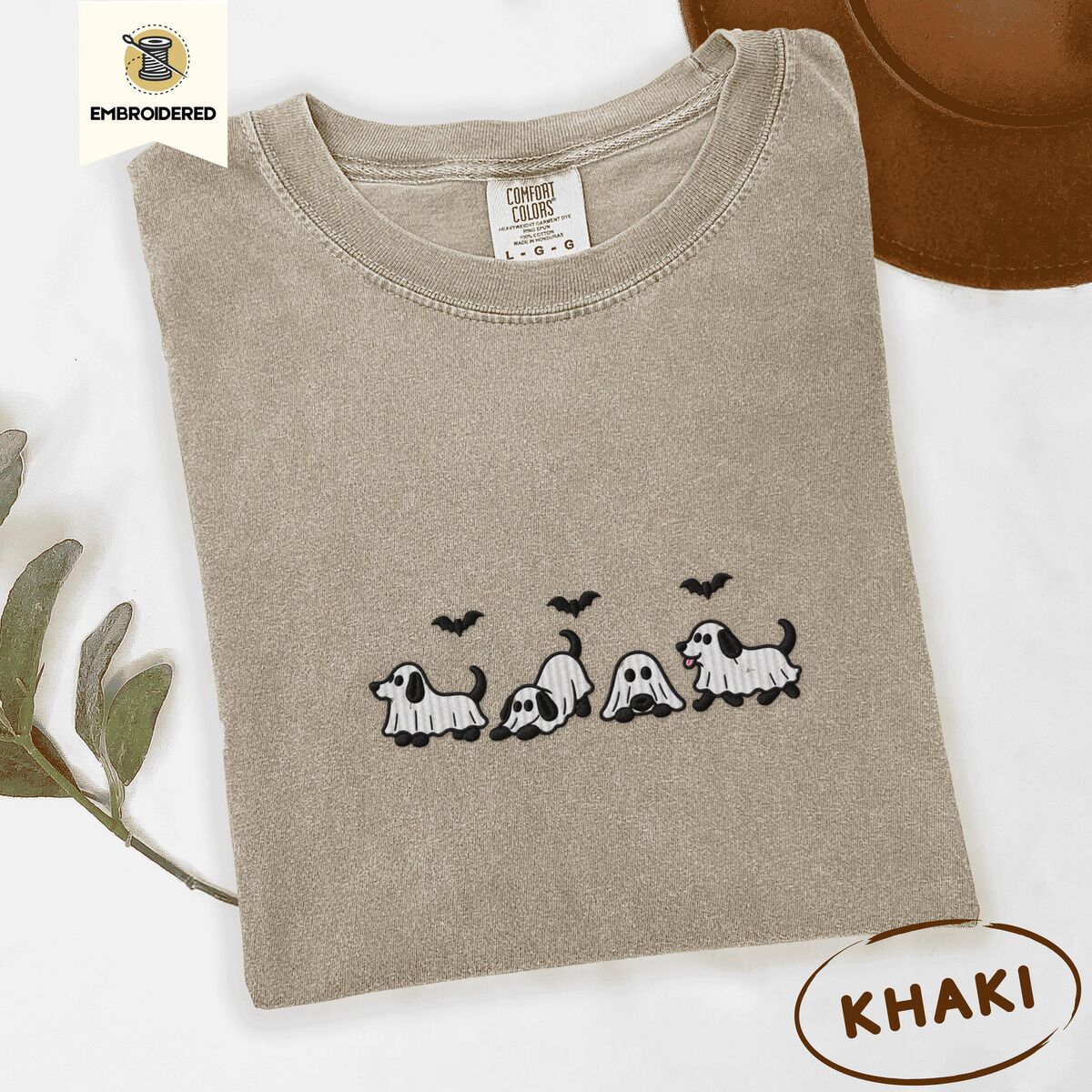 Ghost Puppy Shirt – Khaki Khaki Comfort Colors T-shirt embroidered with four puppies in white ghost sheets with black floppy ears and tails under three flying black bats