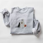 Sport Grey crewneck sweatshirt laid flat on a white background, embroidered with a ghost lab mom sipping iced coffee and carrying a jack-o'-lantern pail, with a black lab sitting against her
