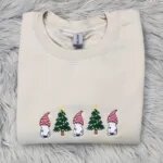 Gnome cat sweatshirt in Sand with three white cats in striped gnome hats and two Christmas trees across the chest