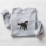 Sport Grey crewneck sweatshirt laid flat with rolled sleeves, a golden retriever silhouette with an American flag stitched in the center