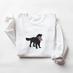 White crewneck sweatshirt laid flat, embroidered with a black golden retriever carrying a red, white and blue flag