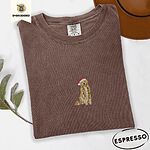 Espresso Comfort Colors T-shirt embroidered with a golden retriever in a red Santa hat holding a strand of colorful Christmas lights