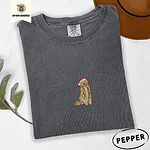 Pepper Comfort Colors T-shirt embroidered with a golden retriever in a red Santa hat holding a strand of colorful Christmas lights