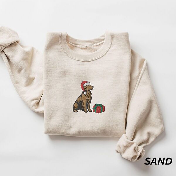 Golden retriever Christmas present sweatshirt in Sand laid flat, embroidered with a golden retriever in a Santa hat beside a red gift box