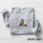 Sport Grey crewneck sweatshirt laid flat, embroidered with a golden retriever in a Santa hat sitting next to a wrapped present