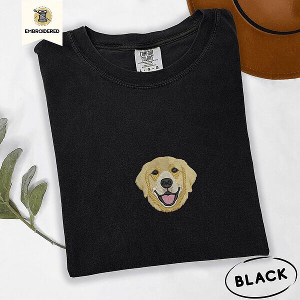 Black Comfort Colors T-shirt embroidered with a smiling golden retriever face with a pink tongue