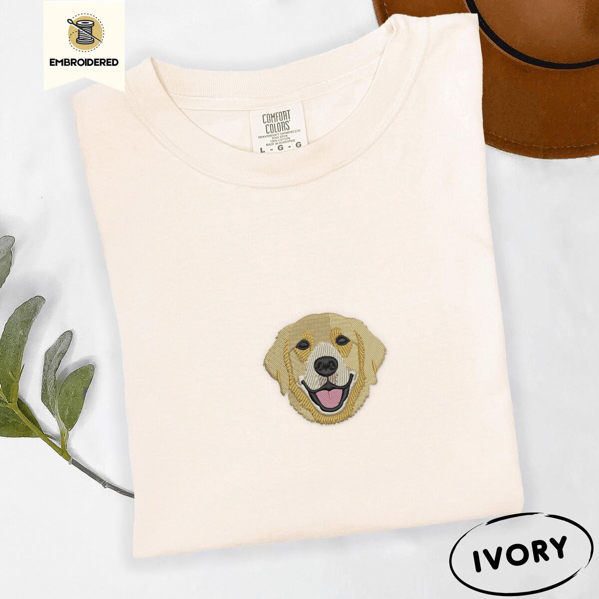 Golden Retriever Face Shirt – Ivory Ivory Comfort Colors T-shirt embroidered with a smiling golden retriever face with a pink tongue