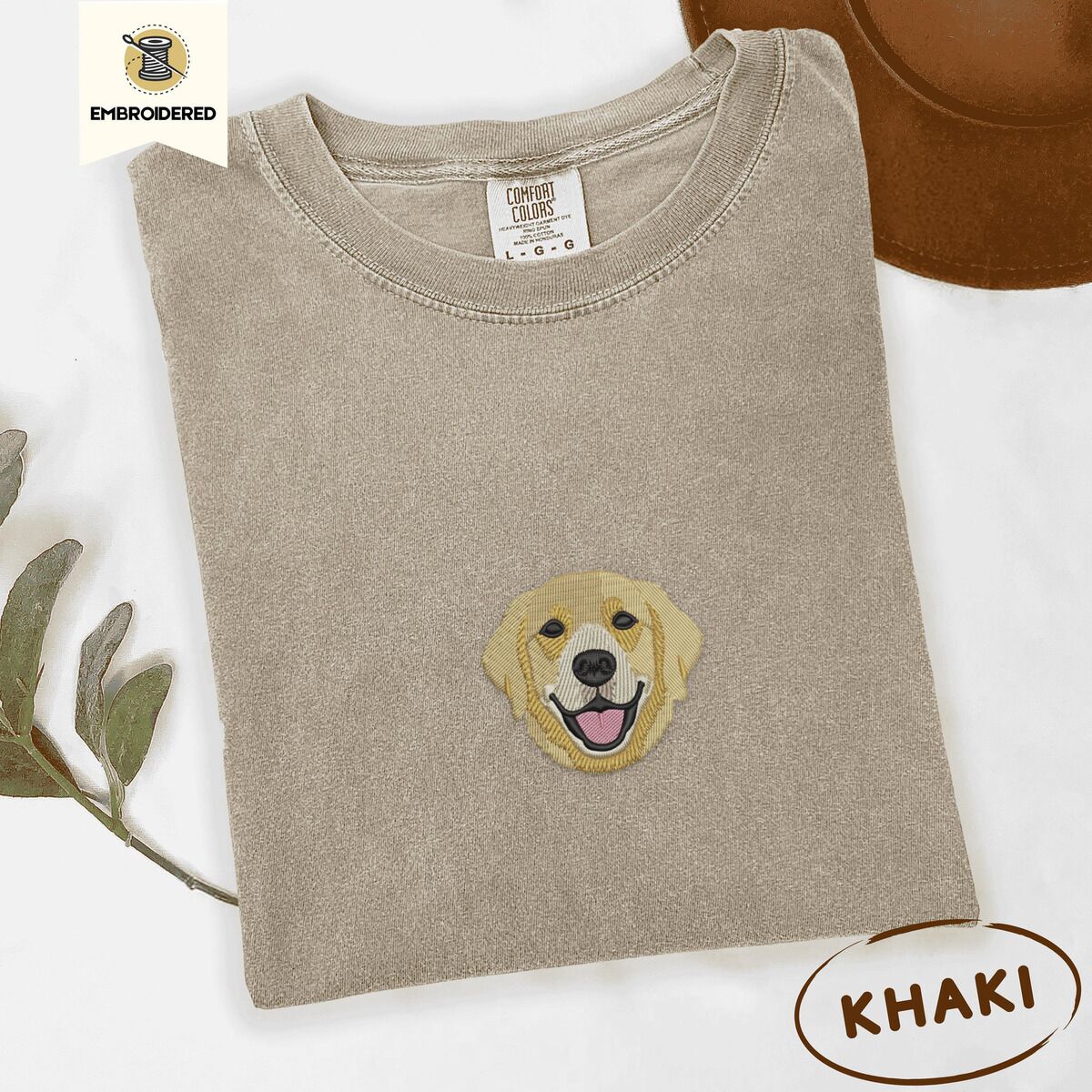Golden Retriever Face Shirt – Khaki Khaki Comfort Colors T-shirt embroidered with a smiling golden retriever face with a pink tongue