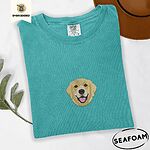 Seafoam Comfort Colors T-shirt embroidered with a smiling golden retriever face with a pink tongue